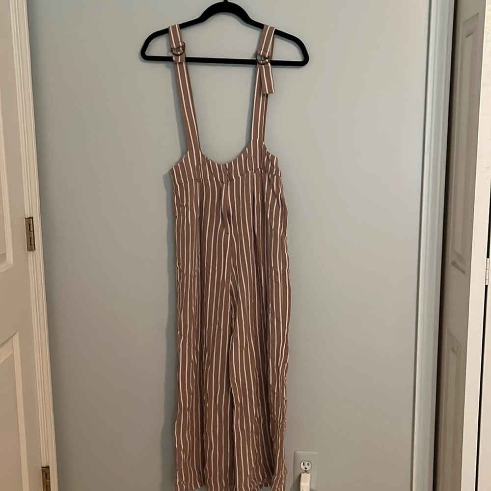 Pink and white forever 21 overalls. Adjustable straps. Loose fitting material.
